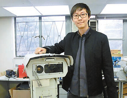 Insight Robotics' co-founder, Rex Sham, with a wildfire detection robot